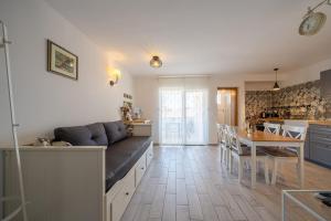 a kitchen with a couch and a table in a room at Apartments TERRAeSAL in Zadar