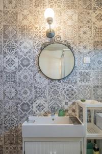 a bathroom with a sink and a mirror at Apartments TERRAeSAL in Zadar +51 photos