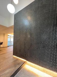 a room with a black tiled wall in a building at VILLA VINO ATAMI m in Atami