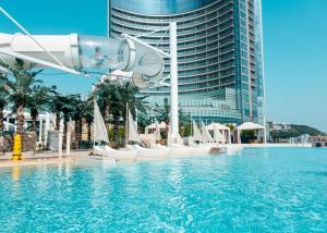 a person in a slide in a pool at a hotel at Haeundae Marine Capsule Hotel&Spa in Busan
