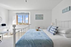 a white bedroom with a bed and a window at Keepers Cottage - Dartmouth Golf and Spa Resort in Dartmouth +42 photos