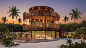 a building with tables and chairs in front of it at Lagoona Eco Resort Binh Chau in Binh Chau