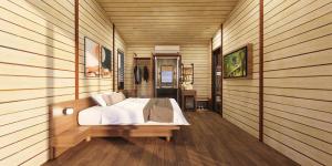 a bedroom with a bed in a room with wooden walls at Lagoona Eco Resort Binh Chau in Binh Chau
