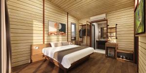 a bedroom with a bed in a wooden room at Lagoona Eco Resort Binh Chau in Binh Chau