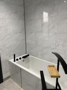 a white table and a black chair in a room at Gite de l'etoile in Rocroi +9 photos