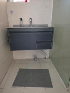 a bathroom with a sink and a tile floor at Nice quite stay in Perth +10 photos