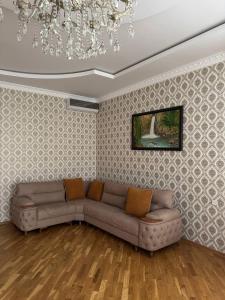 a living room with a couch and a chandelier at House in Katex