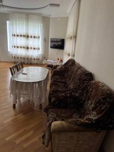 a living room with a couch and a table at House in Katex