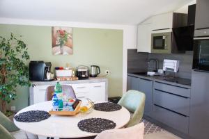 a small kitchen with a table in a kitchen with a tableablish at Sunny oasis in Marčelji +18 photos