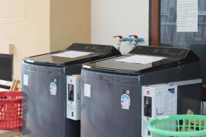 two trash cans sitting next to each other at The Guest Hotel & Hostel in Chiang Mai