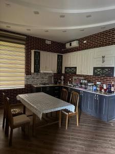 a kitchen with a table and chairs and a counter at House in Katex +18 photos