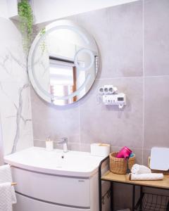 a bathroom with a white toilet and a mirror at Sunny oasis in Marčelji