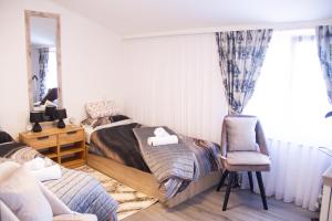 a bedroom with a bed and a chair and a mirror at Sunny oasis in Marčelji