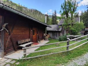 a wooden cabin with a fence next to it at Ciasa Lovara in Lovara