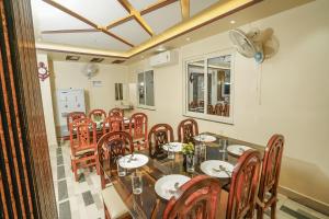 a dining room with a long table and chairs at Hotel Sea Wood in Digha
