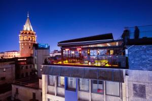 a building with a clock tower in a city at Duo Galata Hotel in Istanbul