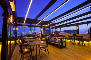 a restaurant with tables and chairs on a roof at Duo Galata Hotel in Istanbul