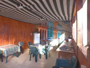 a room with tables and chairs and a building at Vila Hipo in Venus