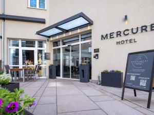 a sign in front of a mercure hotel at Mercure Hotel Hannover City in Hannover