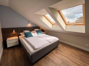 a bedroom with a bed in a attic at Villa Continental in Pobierowo