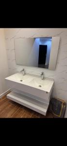 a bathroom with a white sink and a mirror at شاليه دار وارف in As Sayl aş Şaghīr +17 photos