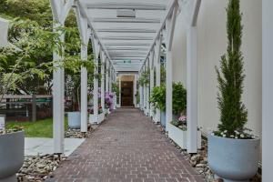 a walkway in a building with potted plants at Living am Carlsplatz Apartment in Düsseldorf