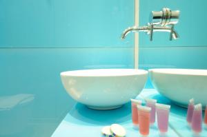 a bathroom with two bowls and a sink at Louloudis Fresh-Adults Only in Skala Rachoniou