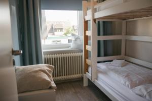 a bedroom with two bunk beds and a window at Haus Isabel in Büsum