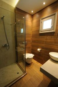 a bathroom with a shower and a toilet and a sink at Louloudis Fresh-Adults Only in Skala Rachoniou