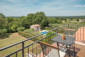 a view from the balcony of a house with a table at Apartment Complex Vetrina-Shared Pool in Nova Vas