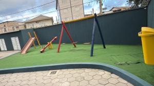 a playground with different kinds of playground equipment at Apartamento 2 quartos na baixada in São Vicente
