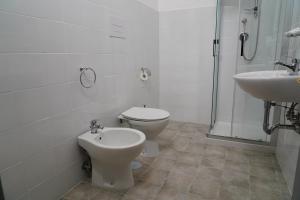 a white bathroom with a toilet and a sink at B e B LEMI in Ponte