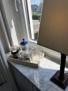 a tray of dishes sitting on a window sill at Haus Isabel in Büsum +95 photos