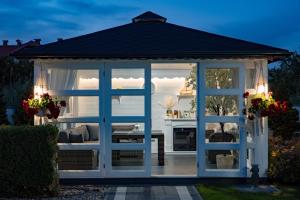 a gazebo in a garden at night at Perla Mare Apartamenty in Krynica Morska