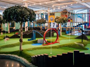 a playground with a red slide and a tree at Quality Hotel Sarpsborg in Sarpsborg