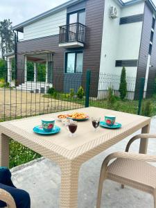 a picnic table with two plates of food on it at Kaprovani Sani Villa in Urekis Sadguri