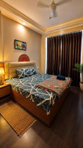 a bedroom with a bed and a large window at Arya homestay in Greater Noida