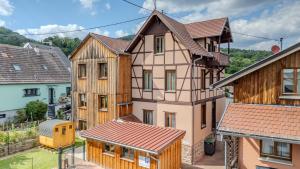 an image of a house with wooden buildings at PINOT GRIS - Charmant studio au cœur du vignoble - parking gratuit in Riquewihr