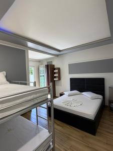 a bedroom with two bunk beds in a room at Hotel Golden in Shkodër