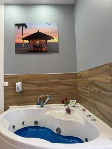 a bath tub with a gazebo in a bathroom at Hotel Golden in Shkodër +45 photos