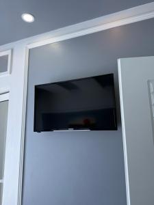 a flat screen tv hanging on a wall at Hotel Golden in Shkodër