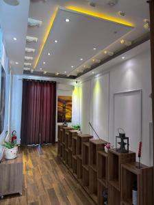 a waiting room with a row of benches and a stage at Hotel Golden in Shkodër