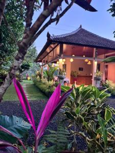 a pink flower in front of a house at Tanah Wuk Villas near ubud in Sangeh