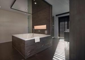 a large bathroom with a tub in a room at Van der Valk Hotel Nuland - 's-Hertogenbosch in Nuland +34 photos