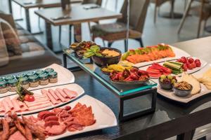 a buffet with several plates of food on a table at Meliá Frankfurt City in Frankfurt