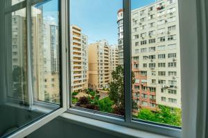 a window with a view of a city at Urban Nest in Chişinău