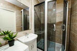 a bathroom with a sink and a shower at Urban Nest in Chişinău +10 photos