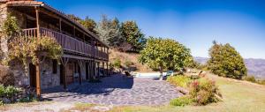 a building with benches in front of it at Mas Lartigues in Taurinya