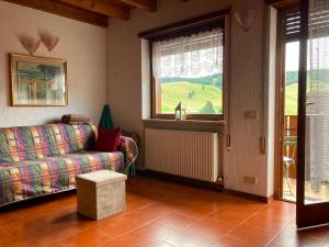 a living room with a couch and a window at Chalet Iris in Bertigo