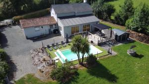 an aerial view of a house with a swimming pool at La maison Callinora in La Chapelle-Saint-Étienne